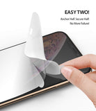 iPhone XS Max Screen Protector | Dual Easy Film - Hand applying a clear screen protector to an iPhone screen.
