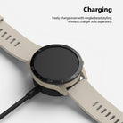 Xiaomi Mi Watch 46mm | Bezel Styling 46-01 - Beige smartwatch with black bezel styling charging on a wireless dock.
