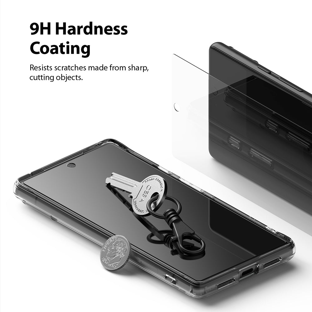 Google Pixel 6 Screen Protector | Invisible Defender - A key and coin resting on a phone screen with a 9H hardness label.