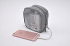 Travel Organizer Pouch - Grey mesh pouch containing a charger, connected by a cable to a rose gold smartphone.