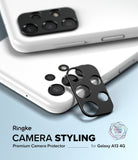 Galaxy A13 4G (LTE) | Camera Styling - Black adhesive camera lens protector being applied to a white Galaxy A13 phone.