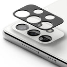 Galaxy A33 5G / A53 5G / A73 5G | Camera Styling - Black protective camera lens cover hovering above a white smartphone.