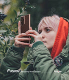 Galaxy Note 20 Ultra Case | Fusion - Person with pink hair in a green jacket holding a clear-cased phone outdoors.