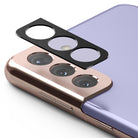 Galaxy S21 | Camera Styling - A black protective camera lens cover hovering above the triple-lens module of a lavender smartphone.