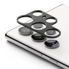 Galaxy S22 Ultra | Camera Styling - Black metal lens protector frame hovering above the white phone's camera array.