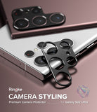 Galaxy S22 Ultra | Camera Styling - Black metal camera lens protector frame resting on a white Galaxy S22 Ultra smartphone.