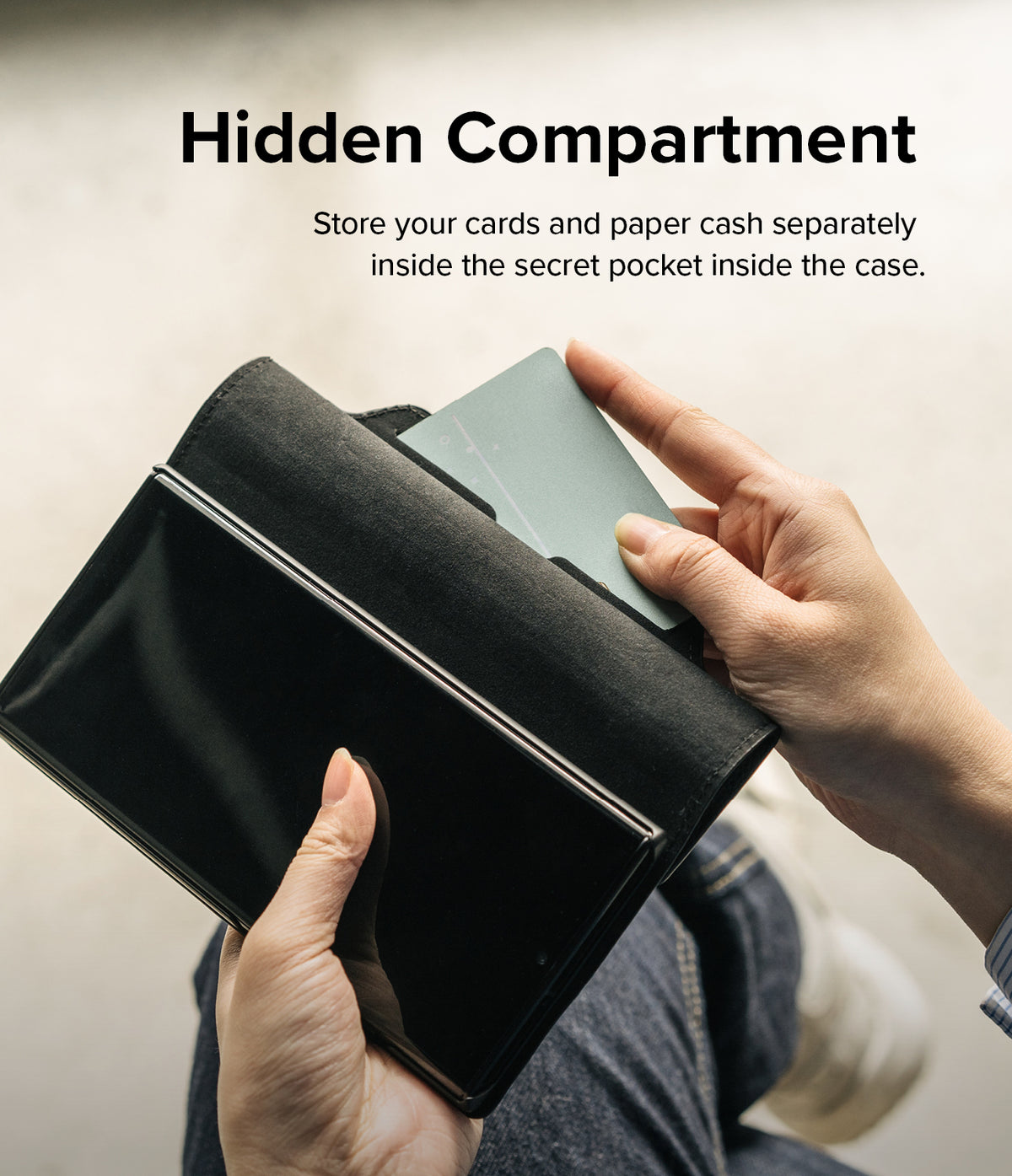 Galaxy S22 Case | Folio Signature Standard - Hand sliding a card into a hidden pocket inside a black leather phone case.