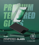 Galaxy S22 Plus Screen Protector | Invisible Defender Glass [2P] - Galaxy S22 Plus Screen Protector - Tempered glass sheet floating above a Galaxy S22 Plus phone on a green background.