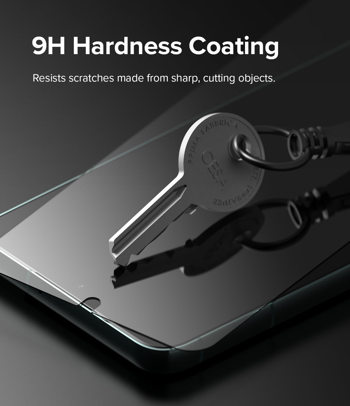Galaxy S22 Plus Screen Protector | Invisible Defender Glass [2P] - Galaxy S22 Plus Screen Protector - A metal key rests on a glass screen protector, demonstrating 9H scratch resistance.