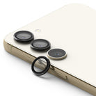 Galaxy S23 / S23 Plus Camera Lens Protector | Camera Lens Frame Glass - Galaxy S23 / S23 Plus Camera Lens Protector - Three black lens covers installed on a cream phone, with one detached.