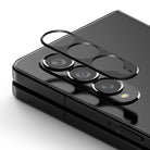 GIFT SET | Galaxy Z Fold 4 - Black camera lens protector hovering above the triple-lens array of a Galaxy Z Fold 4.