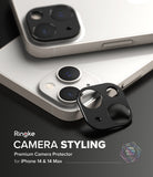 iPhone 14 Plus / 14 | Camera Styling - Black metal camera lens protector being applied to a white iPhone 14 camera module.