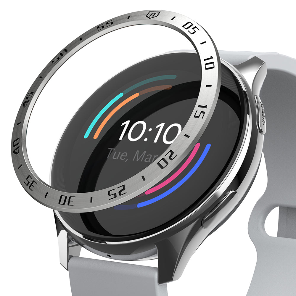 OnePlus Watch 46mm | Bezel Styling - A silver metal bezel ring hovering above a smartwatch with a light gray band.
