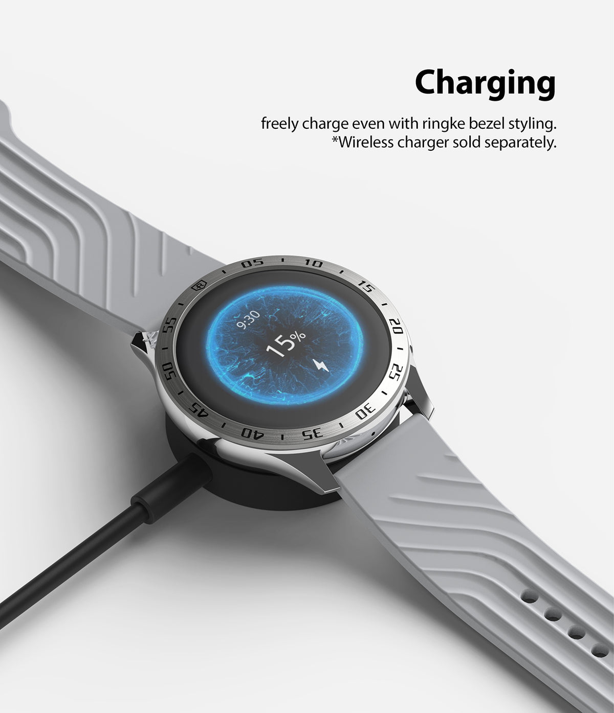 OnePlus Watch 46mm | Bezel Styling - A smartwatch with a silver bezel styling charging on a wireless dock.