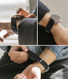 Google Pixel Watch | Rubber One Band - Three views of a black ribbed rubber watch band on a Google Pixel Watch.