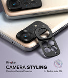 Redmi Note 11S | Camera Styling - Black metal camera lens protector frame being applied to a gold Redmi Note 11S smartphone.