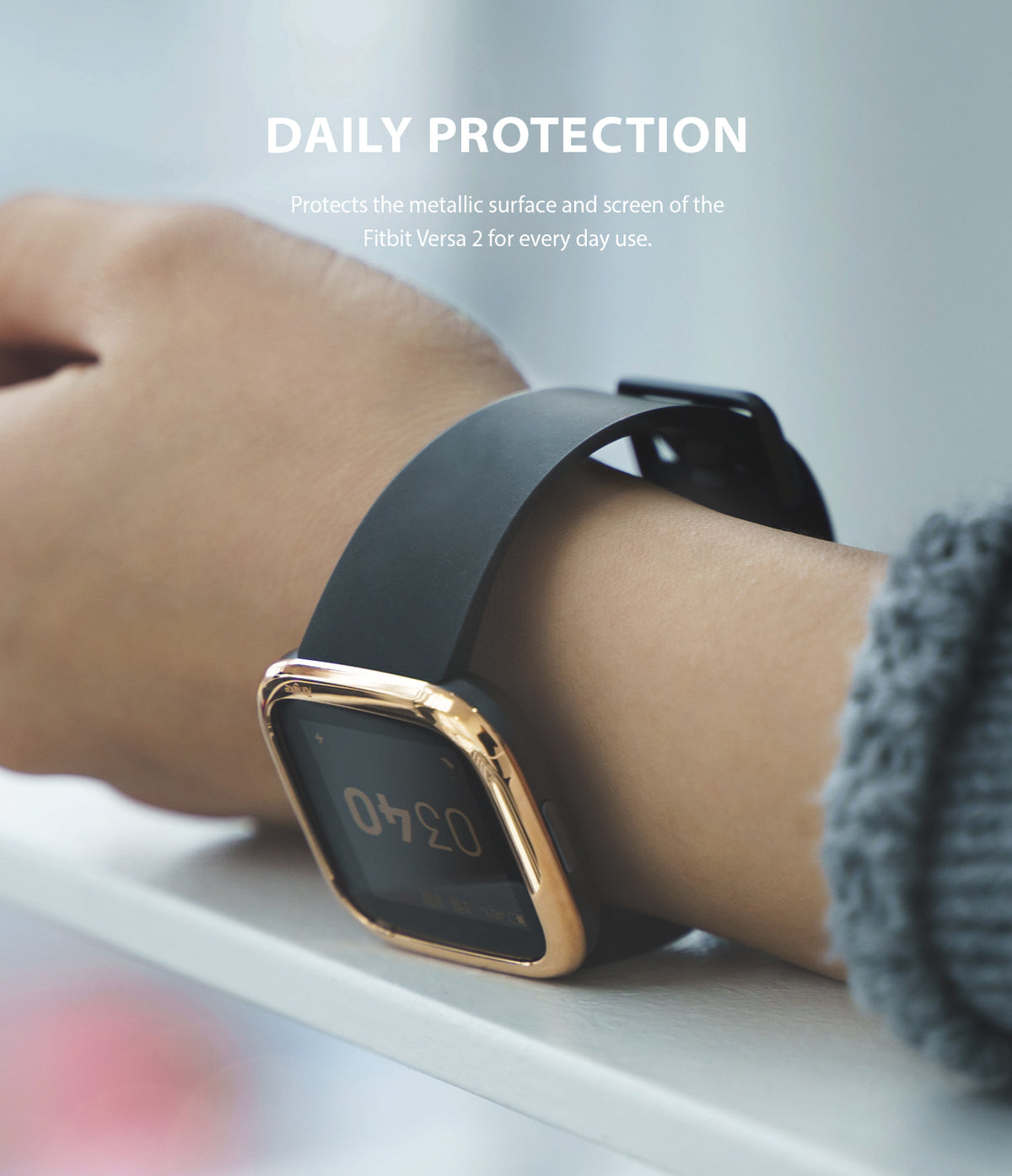 Fitbit Versa 2 | Bezel Styling 01 - A gold-toned protective bezel ring attached to a black Fitbit Versa 2 smartwatch on a wrist.