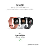 Fitbit Versa | Bezel Styling 01 - Three Fitbit Versa smartwatches in pink, white, and grey displayed side-by-side.