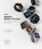 Fitbit Versa | Bezel Styling 01 - Multiple Fitbit Versa smartwatches with colorful, decorative metal bezel rings on a white background.