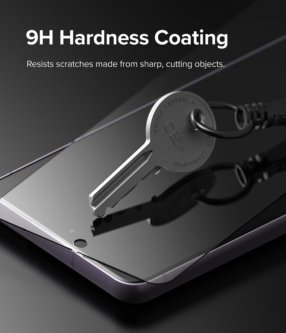 Galaxy S21 FE Screen Protector | Invisible Defender Glass - Galaxy S21 FE Screen Protector - A metal key pressing against a screen protector on a smartphone, demonstrating 9H hardness.