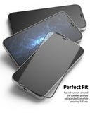 iPhone 12 / 12 Pro Screen Protector | Invisible Defender Glass - iPhone 12 / 12 Pro Screen Protector - Transparent glass screen protector hovering over three stacked iPhone 12 smartphones.