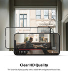 iPhone 13 Mini Screen Protector | Invisible Defender Glass - iPhone 13 Mini Screen Protector - A clear glass screen protector hovering over an iPhone 13 Mini displaying a video.