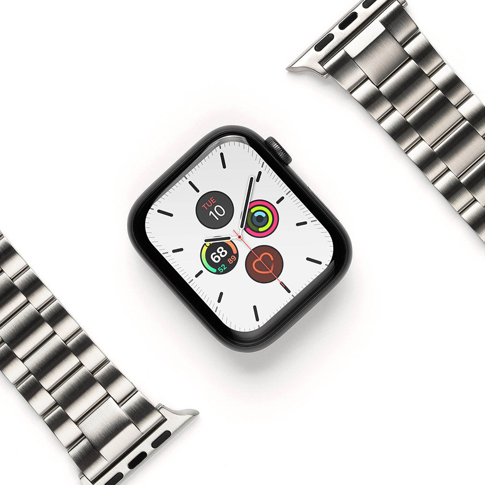 Apple Watch 49·46·45·44·42 mm | Metal One Band - Black Apple Watch with a white face and silver metal link band.